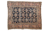 Antique Caucasian rug, dark navy geometric floral gul motif, dusty blush vine border.