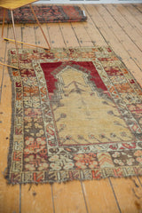Tattered side border of the vintage Melas prayer rug, featuring geometric patterns.