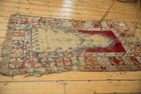 Lower tattered edge of a vintage Melas rug, displaying beige, cherry red, and oxidized silver patterns.