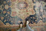 Antique Farahan Sarouk detail, navy field with delicate vinery and notable even wear.