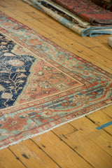 Antique Farahan Sarouk rug corner, wide terra cotta border, elongated vine, navy floral field.