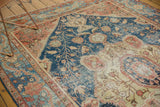 Delicate vinery and floral buds on navy field with terra cotta and ivory tones, even pile wear.