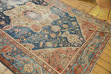 Antique Farahan Sarouk corner, wide banded terra cotta border with meandering floral vines and secured fringe.