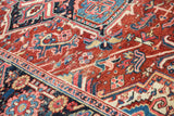 Intricate hand-knotted Heriz rug pattern displaying cherry red, navy, and sky blue motifs.
