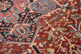 Heriz pile: geometric patterns, cherry red, navy, sky blue, ivory, and visible wear.