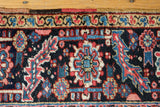 Polychromatic side selvage, intricate serrated leaf border, and geometric field patterns.