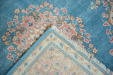 Distressed sky blue Kerman corner, showing tattered edge, fringe, and back.