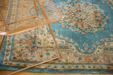 Ornate trefoil floral motifs on the sky blue field of a vintage Kerman rug.