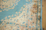 Vintage Kerman rug's sky blue field and ivory, beige curvilinear floral border.