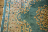 Vintage Kerman rug border with sky blue accents, ivory motifs, and visible selvage pull.