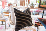 Black chenille velvet throw pillow texture featuring light horizontal stripes.