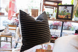 Plush black chenille velvet pillow with crisp white horizontal stripes.