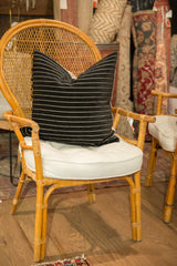 Lower section of black velvet stripe pillow, displaying soft texture.