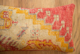 Textured vintage Turkish rug pillow, distressed coral, gold, and beige geometric pattern.