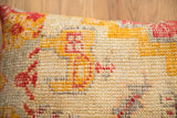 Vintage Turkish pillow showing hand-knotted texture, distressed red and golden motifs.