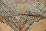 Vintage distressed Oushak runner showcasing soft tangerine, antique ivory, and time-softened pile.