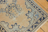 Distressed pale apricot sand and navy blue motifs on the vintage Oushak runner corner.