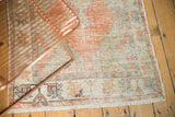 Distressed Oushak rug runner fringe and border with tangerine, black, and beige stylized patterns.