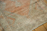 Distressed vintage Oushak runner's worn pile, visible foundation, and muted tangerine beige palette.