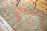 Vintage distressed Turkish Oushak runner, showing even wear, tangerine orange, beige, and silver tones.