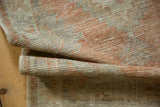 Distressed vintage Oushak rug pile with even wear and visible foundation, tangerine and beige.
