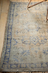 Vintage Distressed Oushak rug corner with even wear, visible foundation, and cobalt blue border.