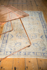 Even wear to knot heads and faded cobalt blue patterns on vintage Oushak rug.
