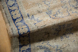 Distressed vintage Oushak rug pile texture with visible knot heads and cobalt blue.