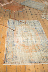 Vintage Distressed Oushak rug with faded medallion in apricot orange, ivory, and denim blue.