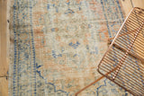 Textured distressed Oushak rug pile with even wear, soft apricot, ivory, and blue.