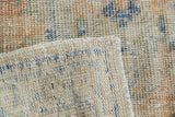 Vintage distressed Oushak rug reverse, revealing tight ivory foundation and worn apricot, blue pile.