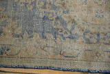 Distressed Oushak runner's textured pile, sky blue and antique ivory tones, with secured side.