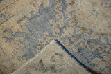 Hand knotted Oushak runner folded, revealing distressed sky blue pile and woven foundation.