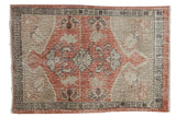 Vintage distressed Oushak rug featuring a dusty rose and beige floral medallion, 2'5