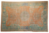 Distressed vintage Oushak carpet, faded tangerine orange, scalloped central medallion, green-blue border. 6'2