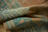 Distressed vintage Oushak rug, highlighting worn texture and faded tangerine and seafoam greens.