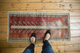 Distressed Oushak runner featuring lavender floral, rust field, and visible wear to foundation.