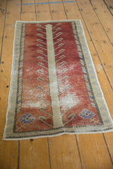 Distressed rust and beige Oushak runner with scrolled tendrils and foundation wear.