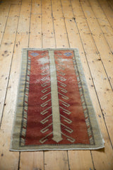 Distressed rust Oushak runner pile featuring beige tree-of-life pattern and lavender accent.