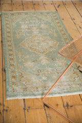 Vintage distressed Oushak rug texture with mostly even wear, seafoam green, dusty gold vinery.