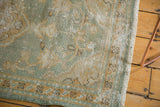 Textured seafoam green Oushak pile revealing mostly even wear and delicate vinery.