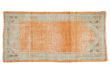 Distressed Oushak rug runner features tangerine prayer field, seafoam border with floral blossoms, 2'2