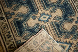 Distressed indigo and sand Northwest Persian rug texture, revealing the hand-knotted foundation.