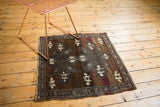 Distressed Oushak corner showing low pile, wear, ivory patterns, and secured edge.
