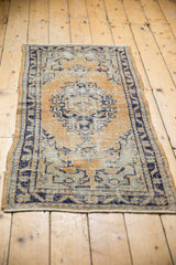 Detail showing distressed pile, wear to knot heads, cobalt blue border, secured edge.