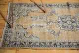 Hand knotted Turkish Oushak corner with distressed dusty gold and cobalt patterns.