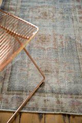 Distressed vintage Oushak runner close-up, showing faded blue, ivory, rose hues and textured pile.