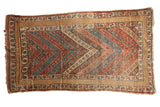 Antique Kurdish rug with vibrant red, blue, beige chevron pattern and distinct wide border.