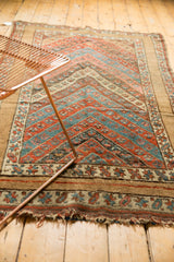 Detail of Antique Kurdish rug: cherry red and sky blue chevron pattern, unique wide border.