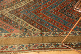 Wide camel main border of the Antique Kurdish rug, with repeating floral inner band.